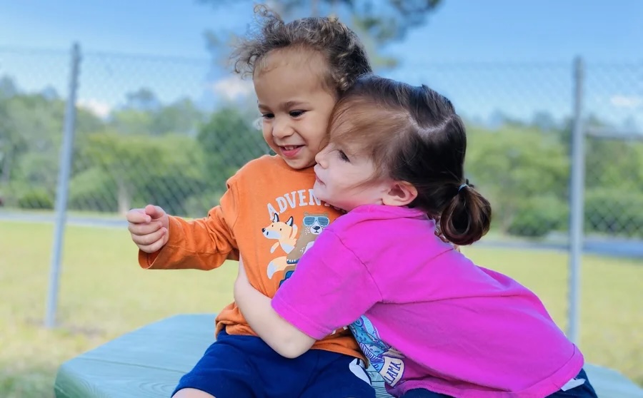 A caregiver spending time with a child at Life House Child Enrichment Station